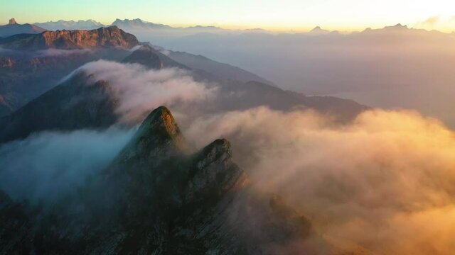 Aerial Descending Scenic Shot Of Clouds Moving On Mountains During Sunset - Cape au Moine, Switzerland