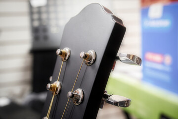 Guitar headstock close up. Black guitar head with chrome tuners