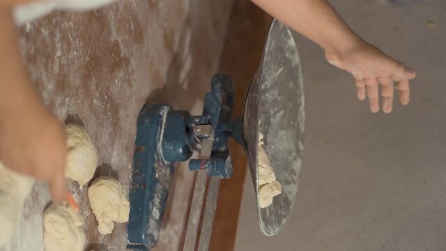 vertical shot of man's hand weighing mass on scales