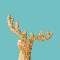 Decorative Christmas tree reindeer ornament close up on a pastel blue background. Winter holiday season minimal concept