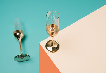Champagne glasses arranged on a geometric perspective background. Minimal New Year celebration concept.