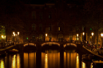 Fototapeta na wymiar Amsterdam Bridge with Lights over Canal