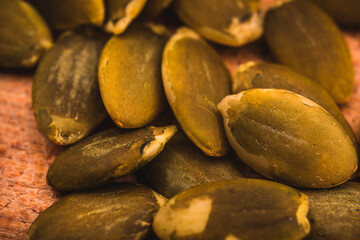 Macro View of Pumpkin Seeds on the Wooden Board.