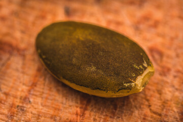 Macro View of Pumpkin Seeds on the Wooden Board.