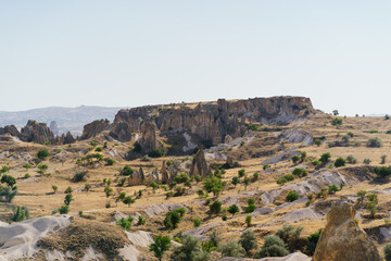Fototapeta na wymiar Picturesque summer view Scenic on landscape view of geologic formations of Cappadocia. Amazing shaped sandstone rocks. Famous touristic place and romantic travel destination..
