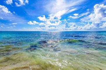 Turquoise clear water boulders stones mexican beach del Carmen Mexico.