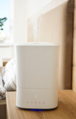 Modern humidifier in the bedroom, closeup. Vertycally.