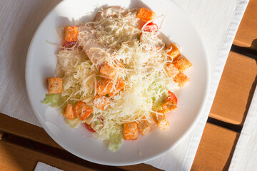 Caesar salad in a street cafe in the sun