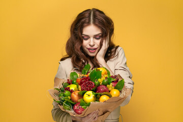 portrait of a woman fun posing fruit bouquet vitamins colorful background
