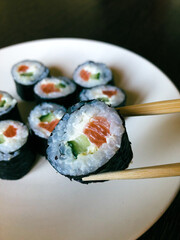 Sake Kappa maki sushi on chopsticks