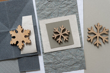 wooden snowflake ornaments on various pieces of paper
