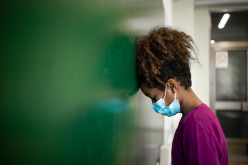 Adjusting to the new normal. Schoolgirl wearing face mask in classroom.