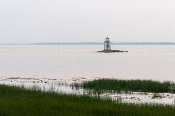 Obraz premium The Saint Peter lake and a lighthouse of the St Lawrence Seaway seen from the Anse-du-Port natural park in the municipality of Nicolet 