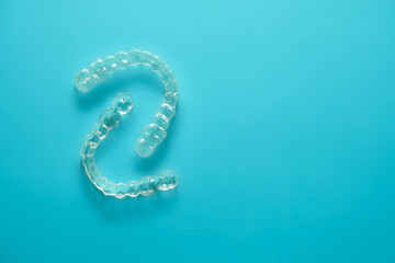 transparent dental retainers on blue background