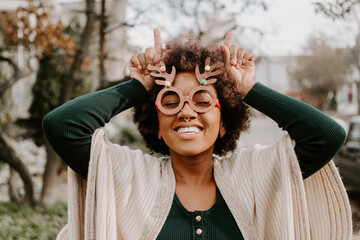 A beautiful girl posing for a portrait wearing antlers