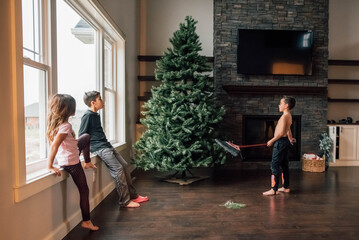 Children looking up at Christmas tree. 