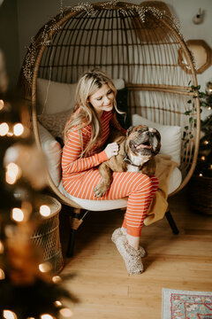 A woman decorating her apartment for Christmas with her pets