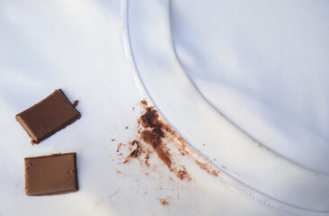 dirty choclate stain on kid shirt from eating for cleaning concept in housework clear