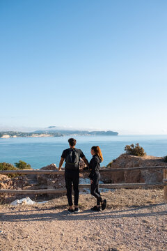 Man and woman observing sea together