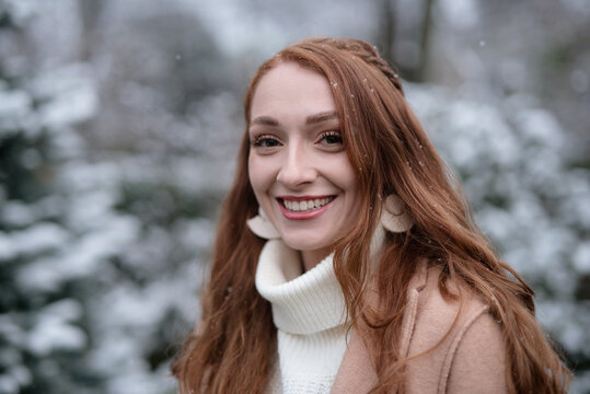 A woman in her twenties standing in the snow