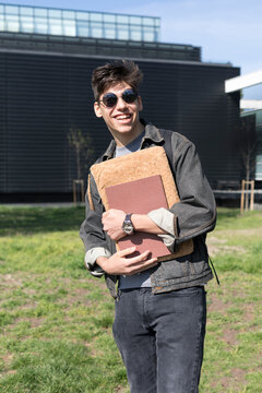 Stylish College Boy Student Holding Books Outdoors