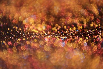 Christmas background. Glowing bokeh. Shining background.Shiny Festive Background. gold glitter texture.soft focus. bokeh background in gold colors.Glowing bokeh.