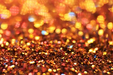 Christmas background. Glowing bokeh. Shining background.Shiny Festive Background. gold glitter texture.soft focus.Beautiful bokeh background in gold colors.