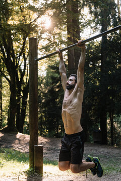 Young Man Exercising Outdoors In Nature on
