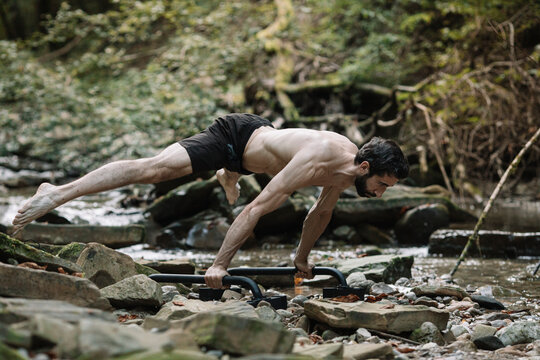 Young Man Exercising Outdoors In Nature