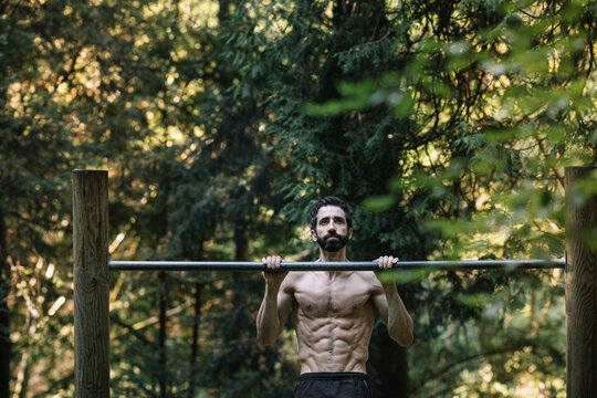 Young Man Exercising Outdoors In Nature on