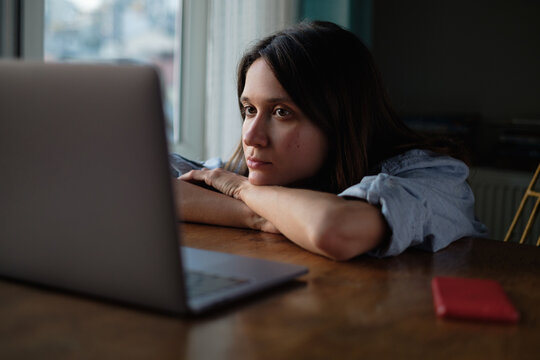 Woman watch something on laptop at home in the evening