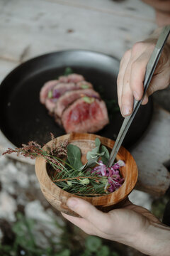 Anonymous Chef Plating Grilled Fillet Outdoors  