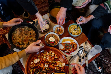 Cenital view of healthy dishes and hands taking food