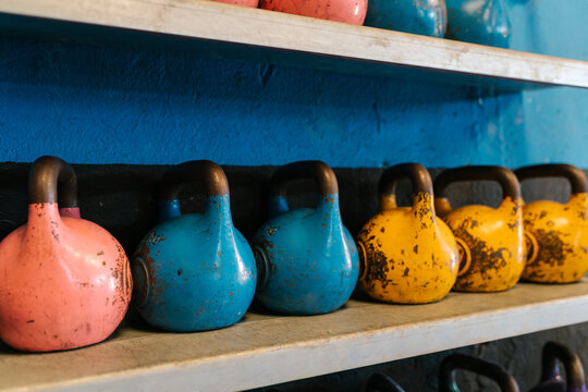 Shabby kettlebells on shelf in gym