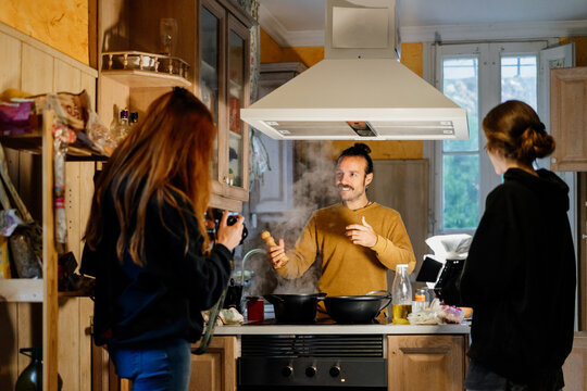 Man cooking healthy food at home being recorded