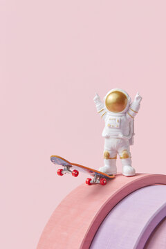Spacemen riding skateboard on pink background