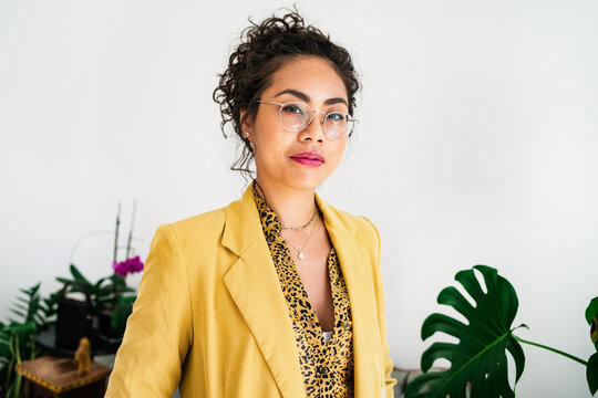Woman in a yellow blazer looking at camera