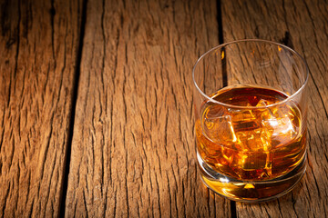 Glass with whiskey and ice cubes.