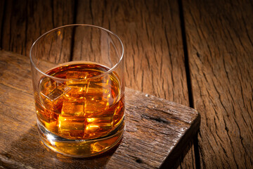 Glass with whiskey and ice cubes.