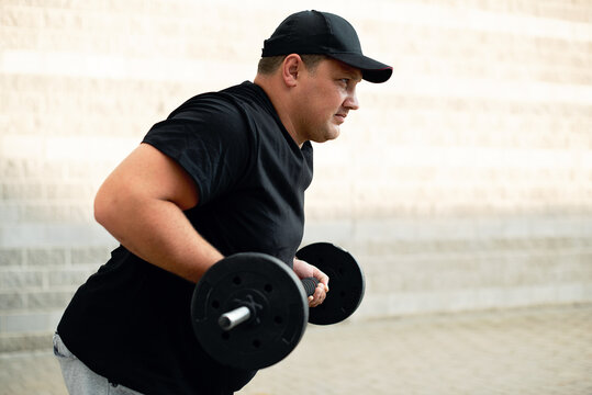 A man in a cap goes in for sports on the street