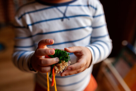 Kid making pompons