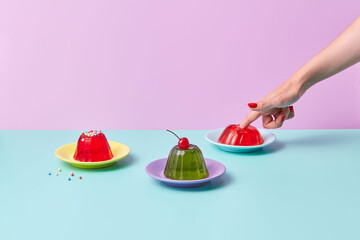 Female poking assorted gelatin desserts