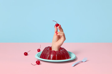 Hand sticks out the jelly dessert