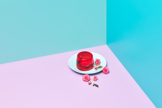 Jelly dessert with roses on plate