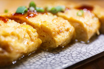 close-up Tamako Yaki cut into pieces,  japanese rolled omelette or sweet egg.