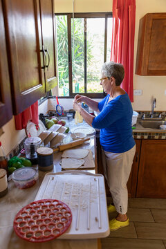 Wide Agle of Senior making homemade dumplings 
