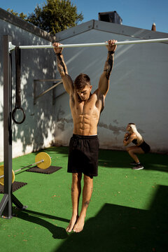 Man doing pull-ups in an Open Gym