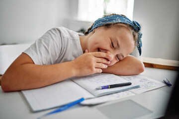 Cheerful girl smiling during doing hometask