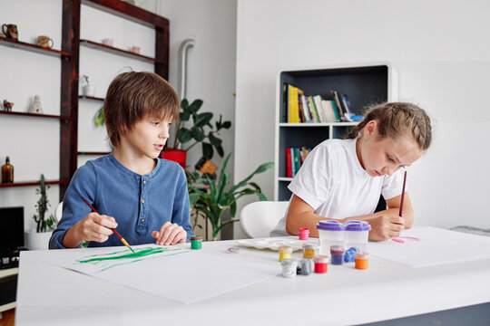 Preschool children studying and drawing at home 