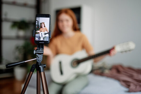 Female student recording video for complete home task